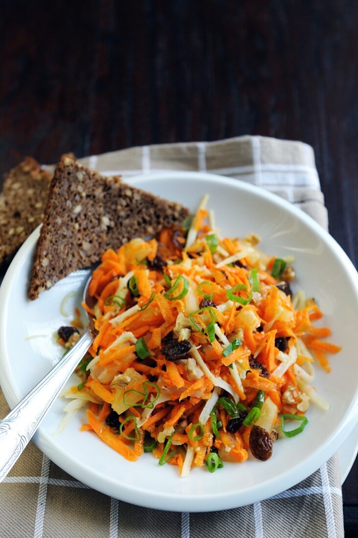 Carrot, raisin, pineapple, cheese, spring onion and walnut salad with rye bread