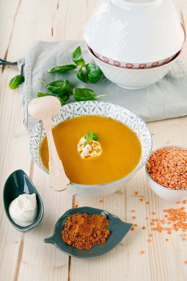 Red lentil soup with curry, creme fraiche and basil