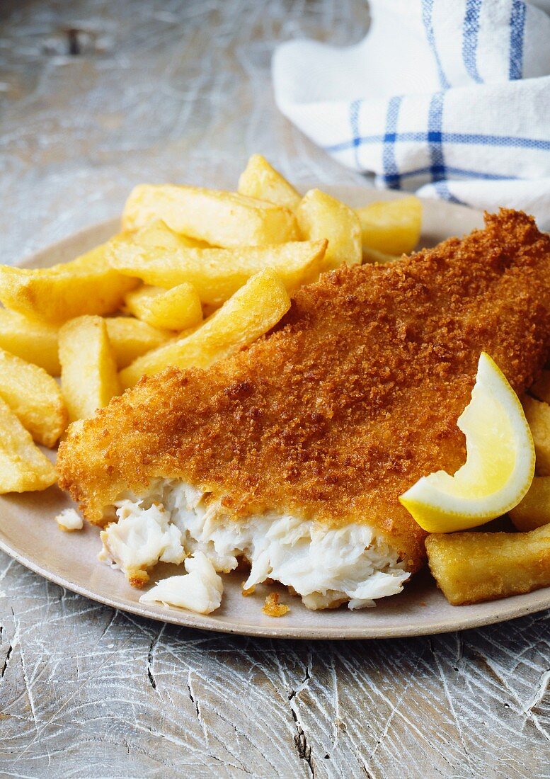 Plate of fish and chips with lemon