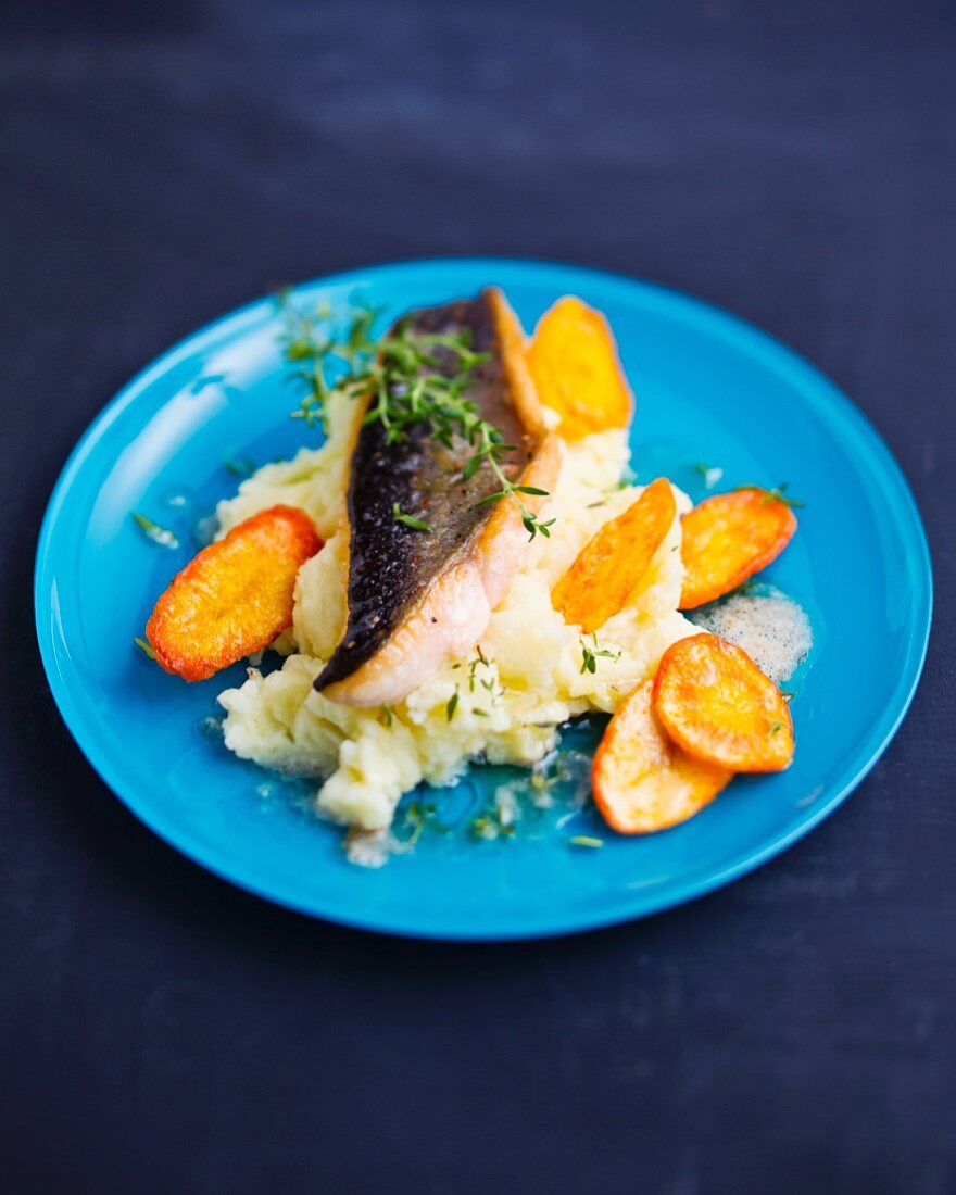 Fried char with mashed potatoes and carrot chips