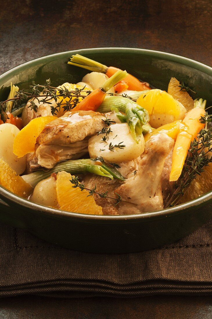 Braised chicken with apple wine, potatoes, oranges and thyme