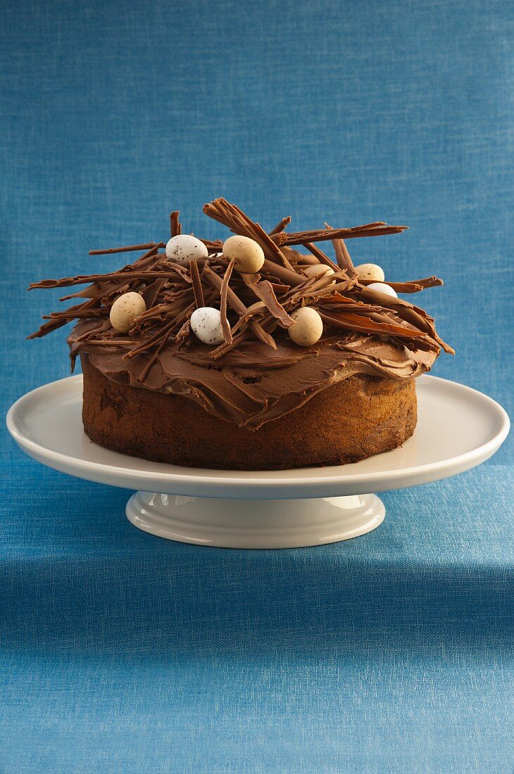 French chocolate cake decorated with chocolate curls and sugar eggs