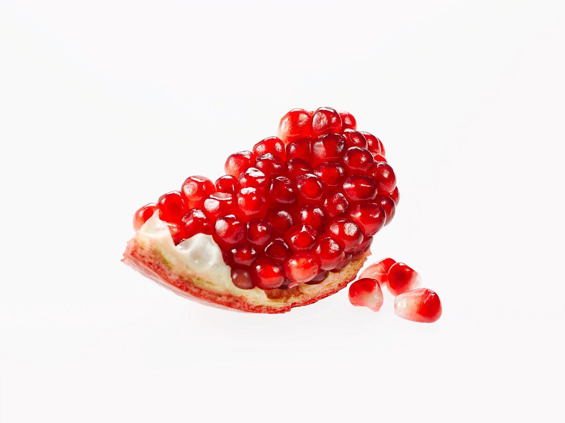 Piece of Pomegranate with Seeds; White Background