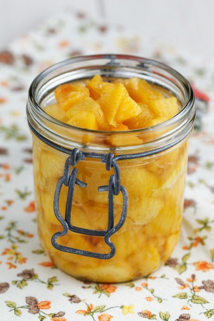Peach compote in a preserving jar