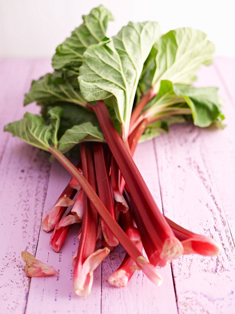 Fresh rhubarb on a wooden surface