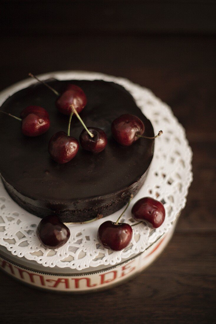 A mini chocolate cake with cherries