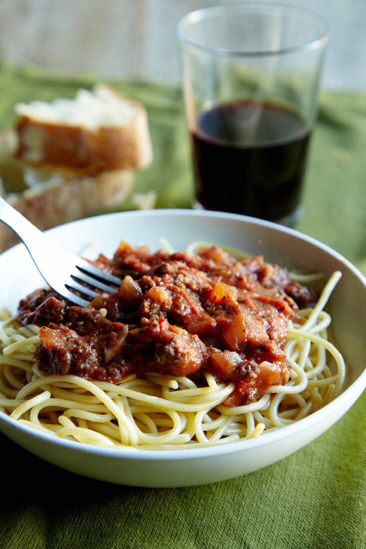 Spaghetti Topped with a Ground Buffalo Tomato Sauce; Bread and Red Wine