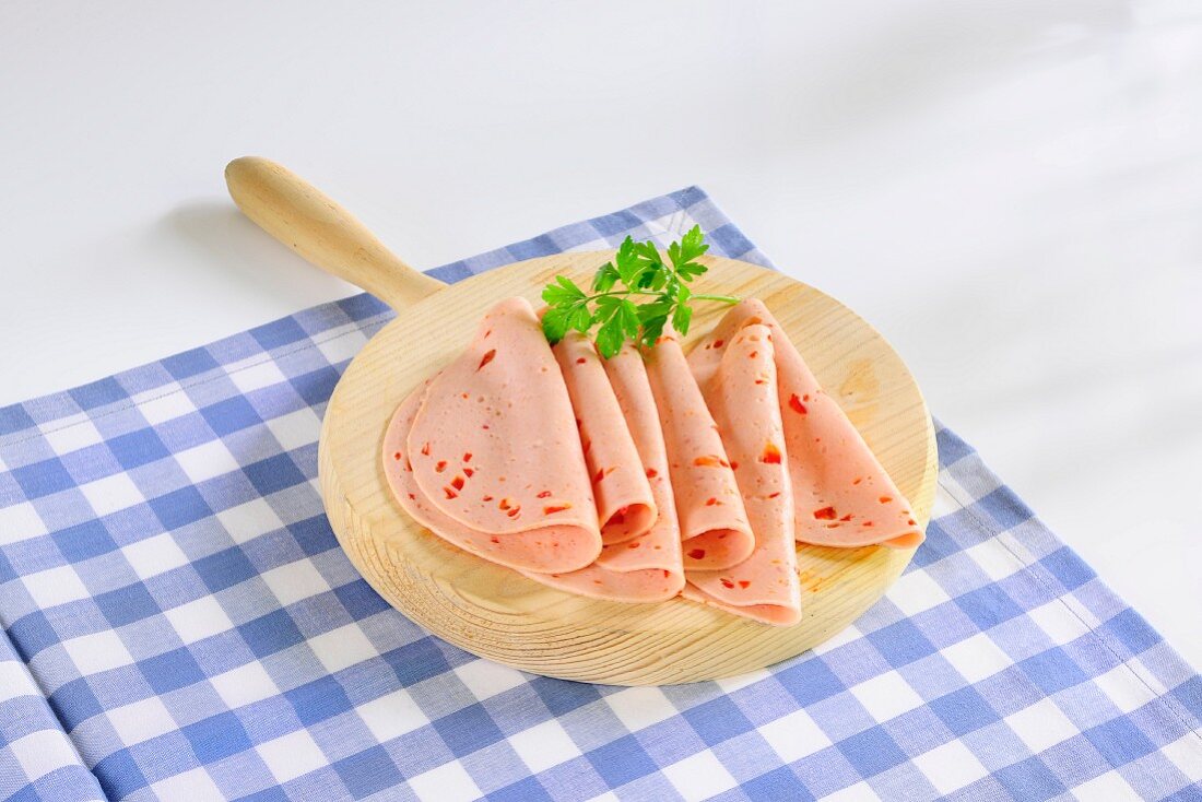 Spiced sausage meat on a wooden plate