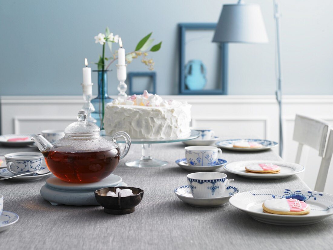 An East Frisian table laid for tea with place cards and a buckwheat cake with lingonberries