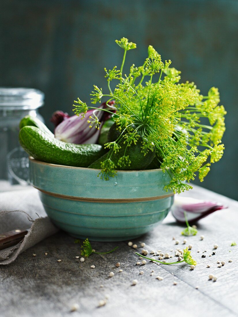 A bowl of gherkins, dill and onions