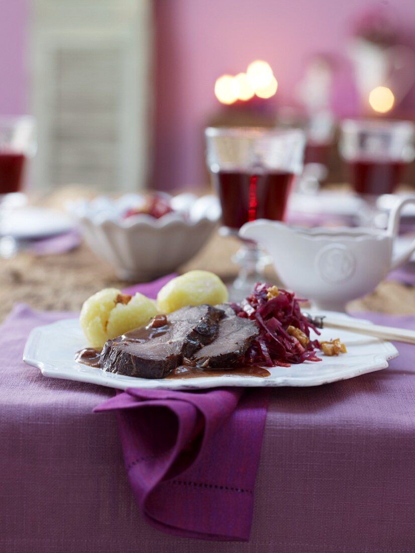 Marinated pot roast with raisin sauce, dumplings and red cabbage