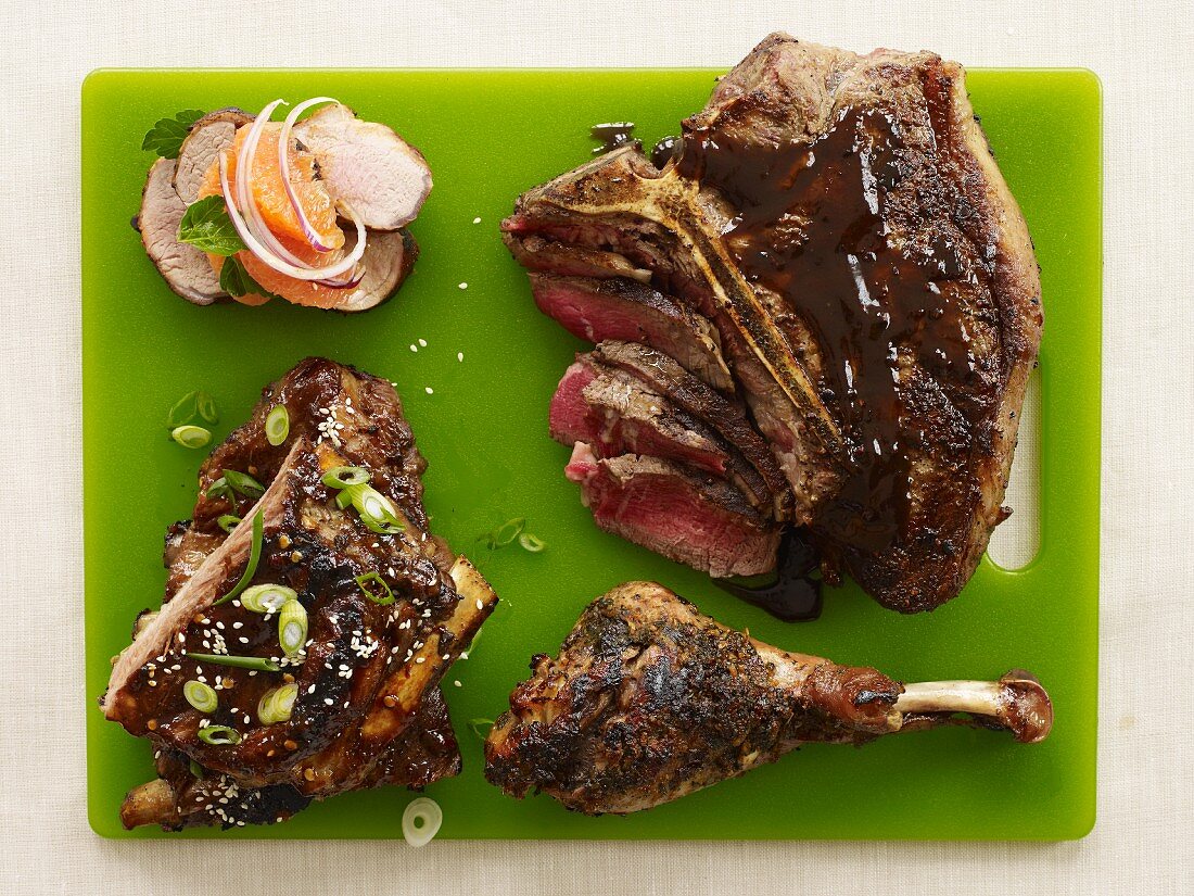 Assorted Barbecued Meat on a Green Cutting Board