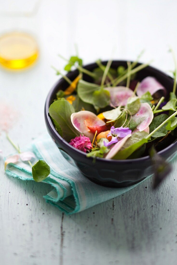 Bittercress salad with watermelon radish, edible flowers and baby carrots