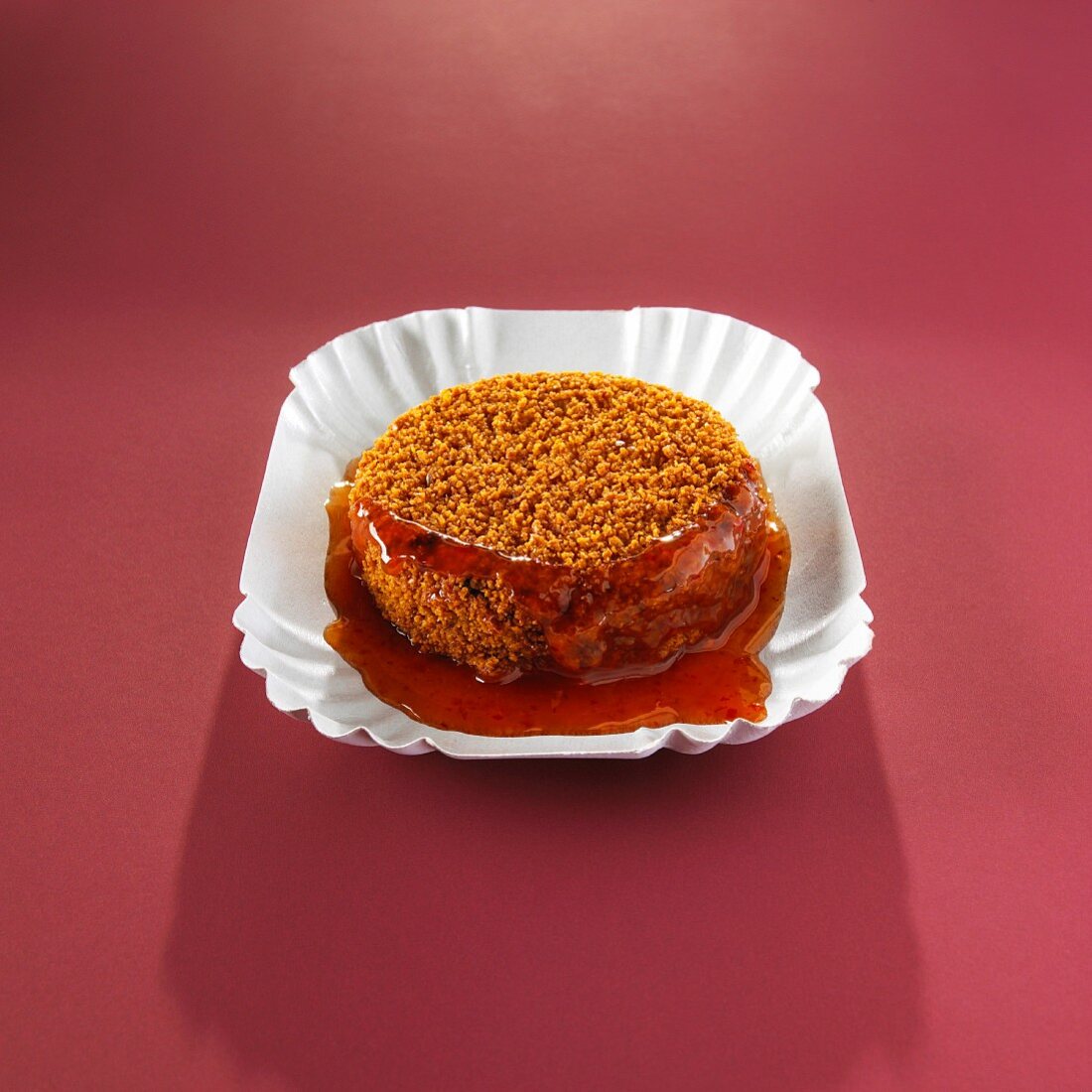 A breaded bami slice with sauce