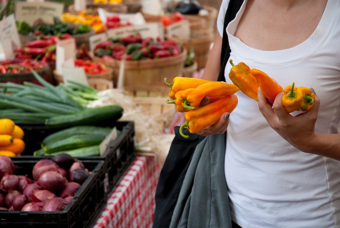 Woman Holding Banana Peppers at a Farmer's Market