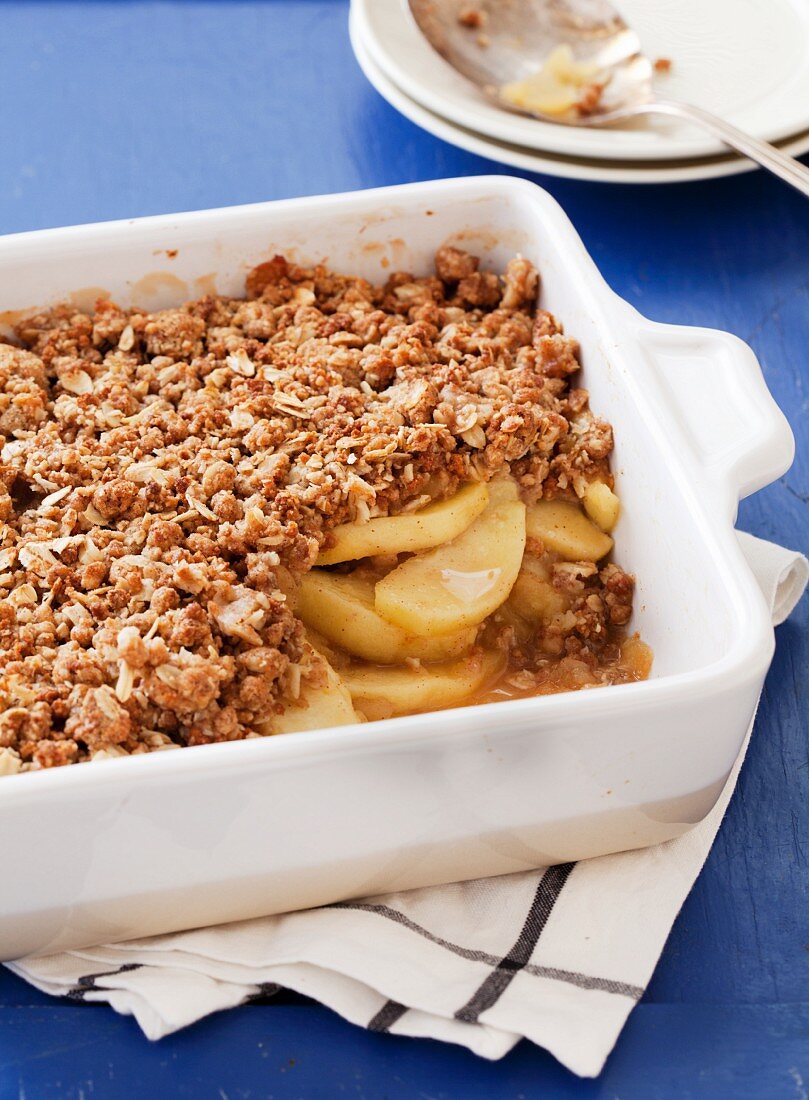 Apple Crisp in a Baking Dish with a Scoop Removed