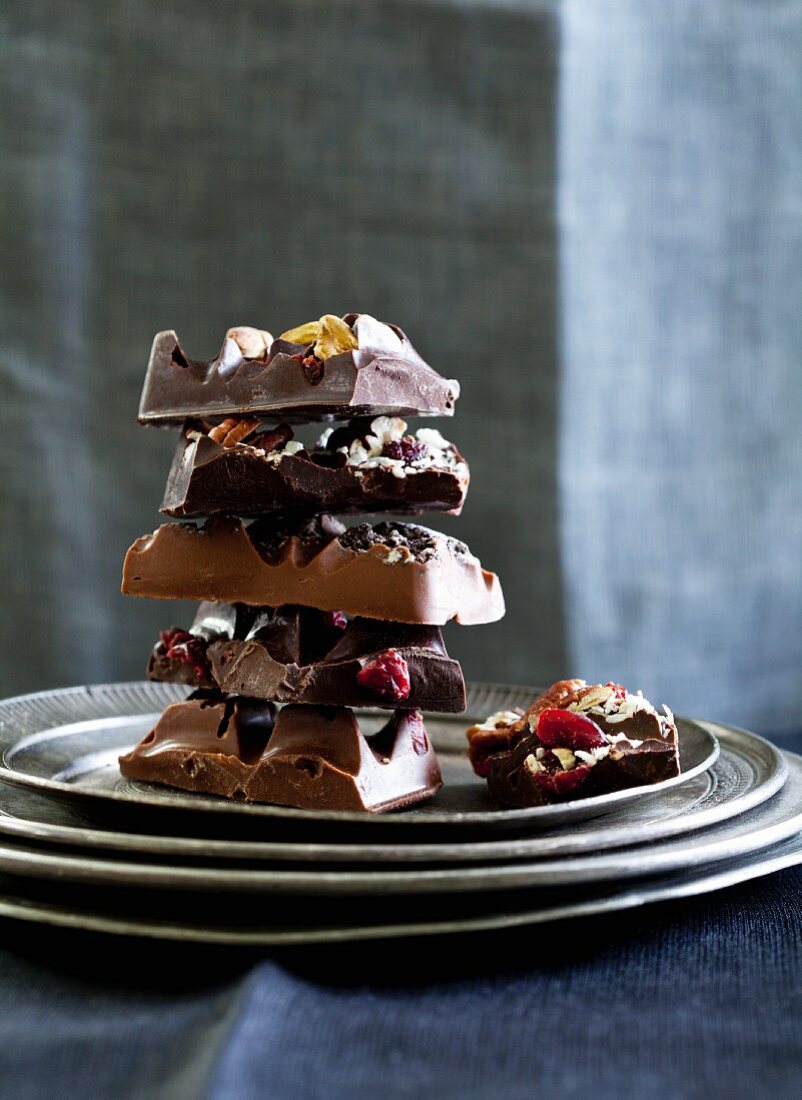 Gestapelte Schokoladenstücke mit Cranberries und Nüssen