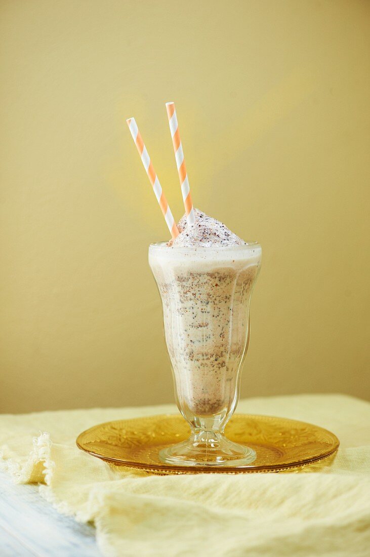 Vanilla Milkshake with Caramel and Chocolate Bits and a Straw