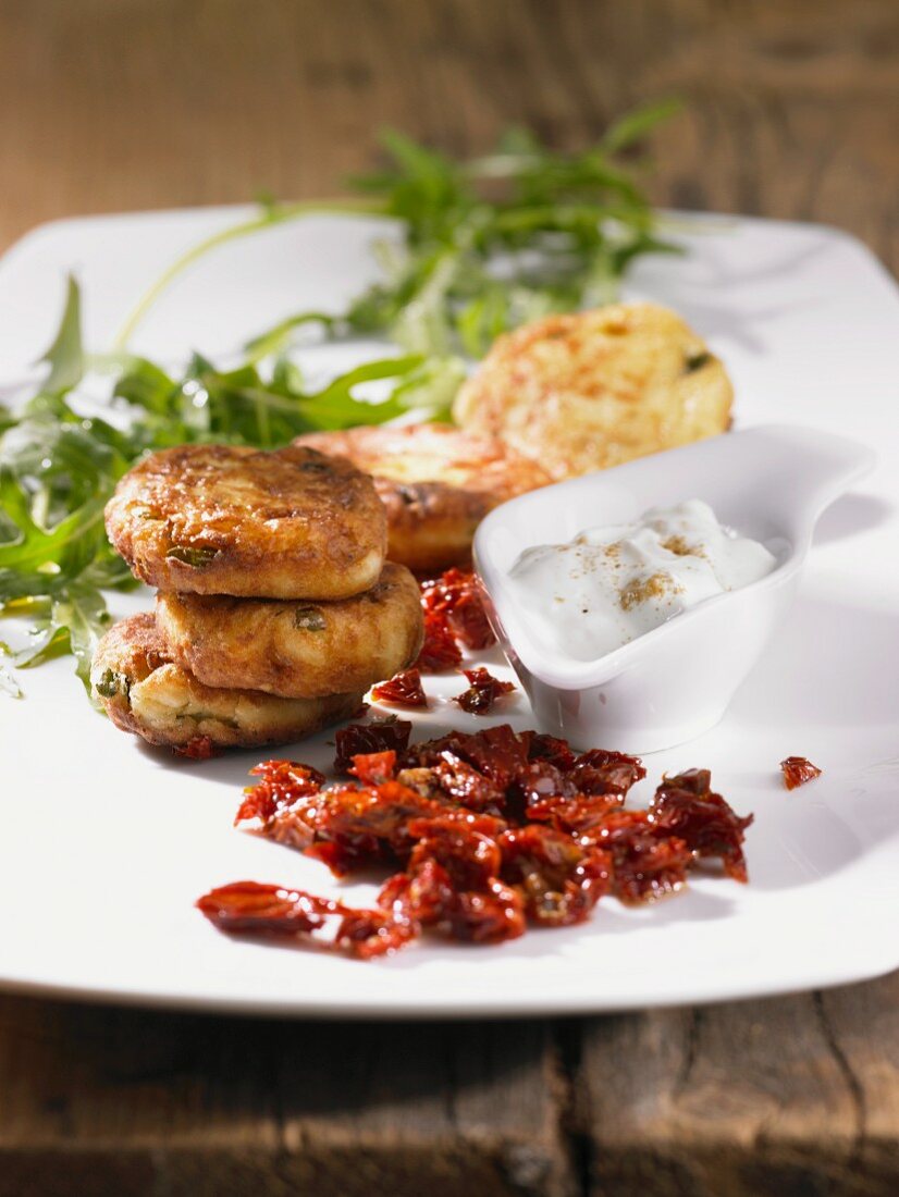 Vegetable fritters with a dip and dried tomatoes
