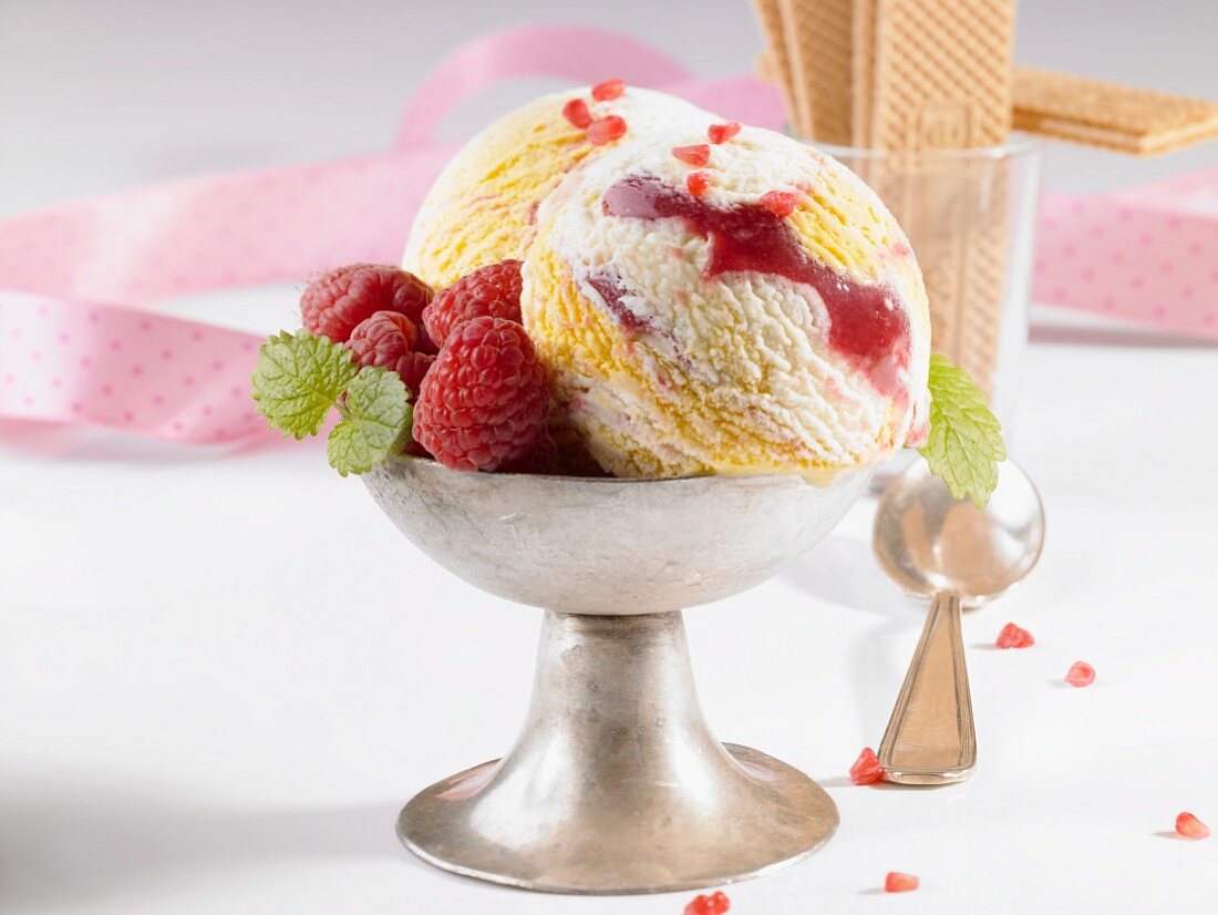 Marbled ice cream with fresh raspberries in an ice cream cup