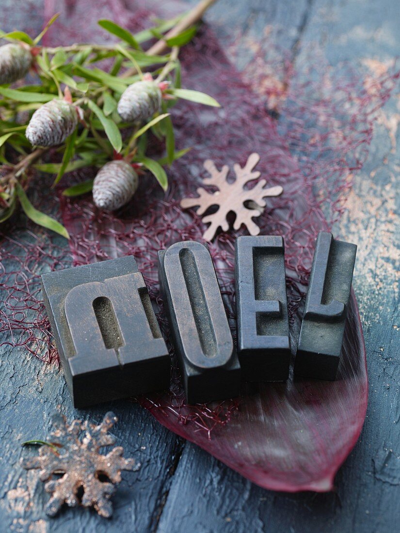 Christmas decorations with letters, pine cones and snowflakes
