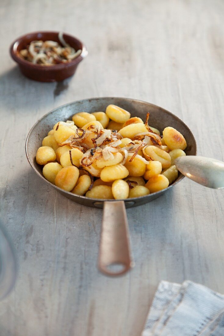 Gnocchi with onions in a pan