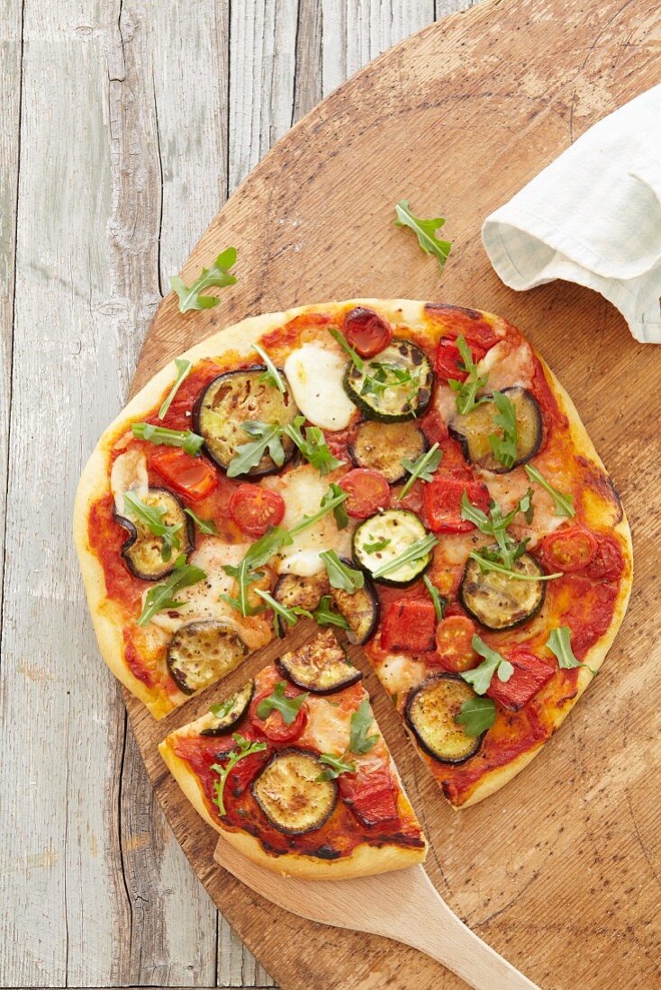 A vegetables pizza with tomato and courgette