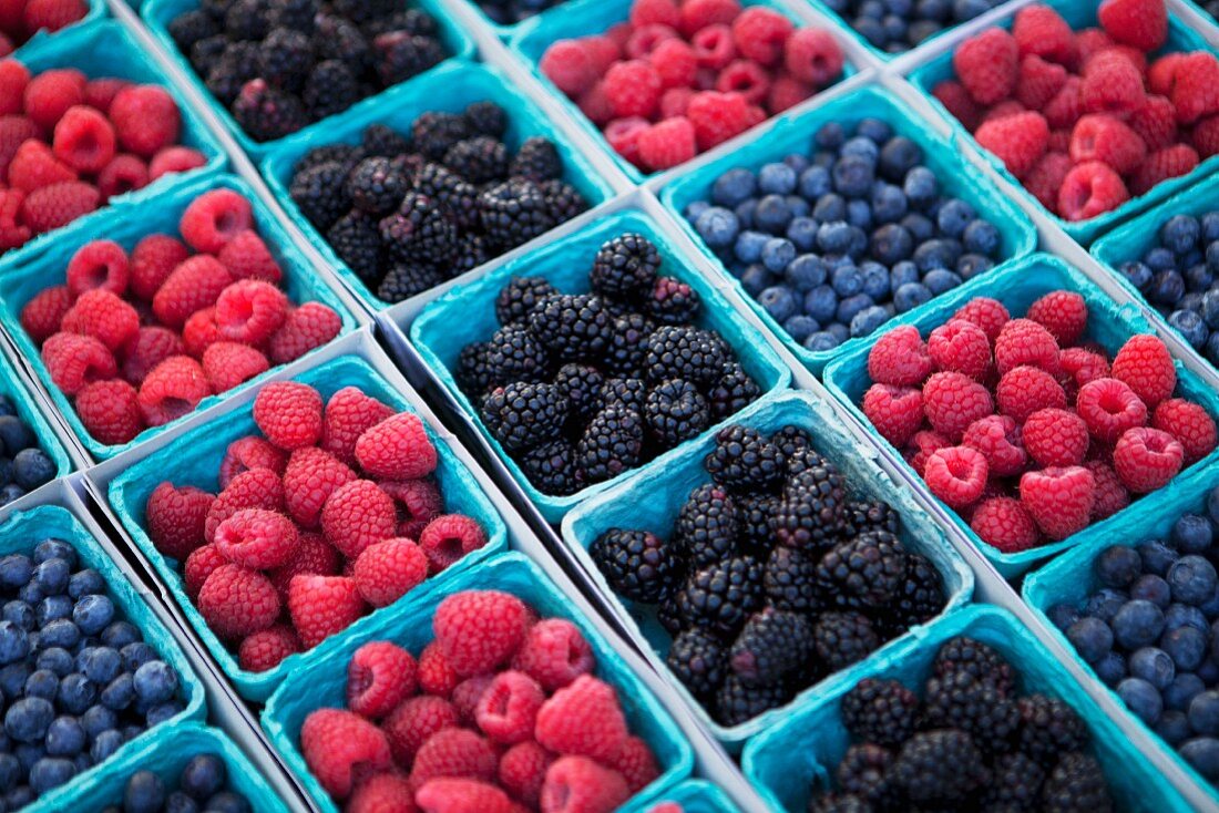 Baskets of Organic Blueberries, Raspberries and Blackberries at a Market