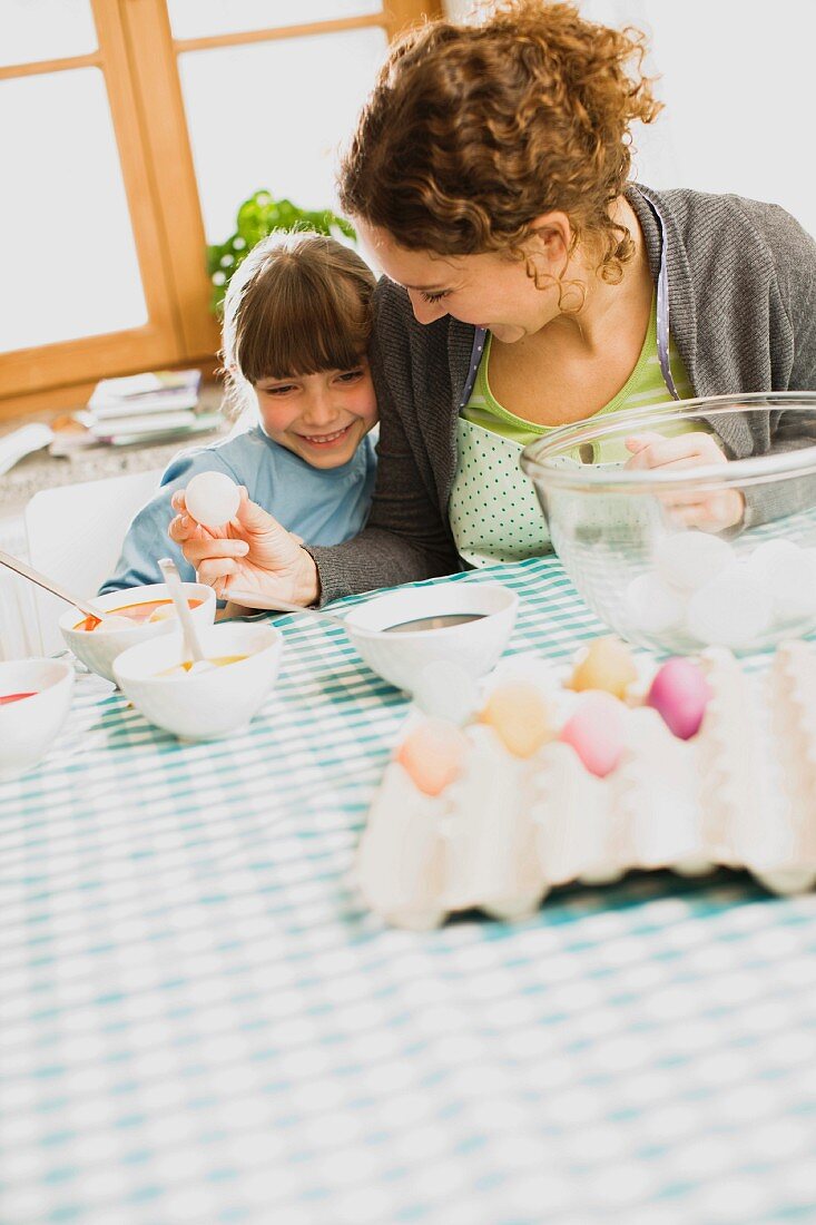 mother and child coloring Easter eggs
