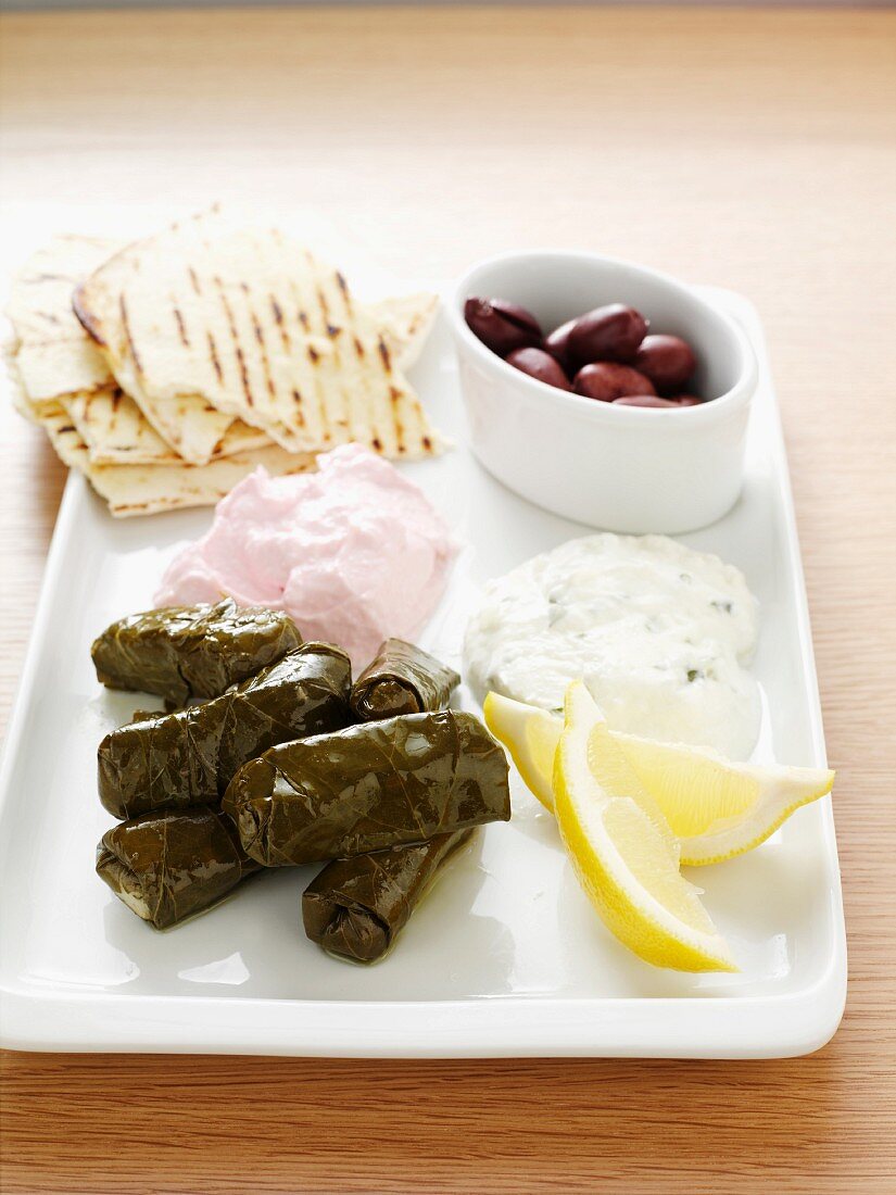 Starter plate with dolmades, tzatziki, tarama, olives and bread