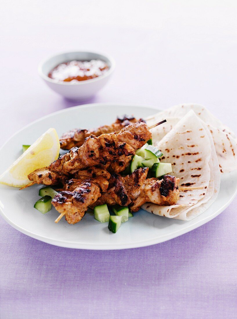 Grilled chicken tikka skewers with flat bread