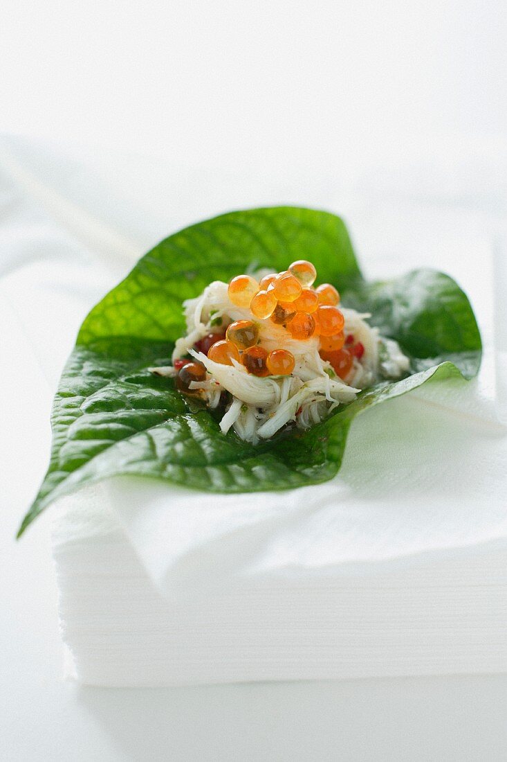 Crab and salmon caviar on a betel pepper leaf