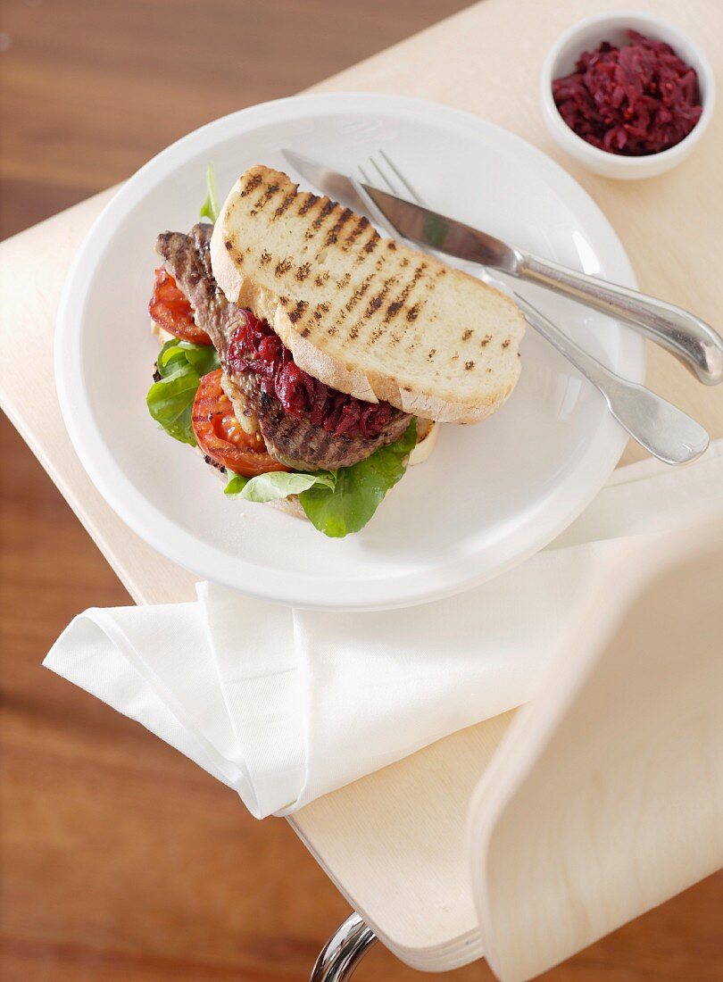 Steak sandwich with red beets and tomatoes