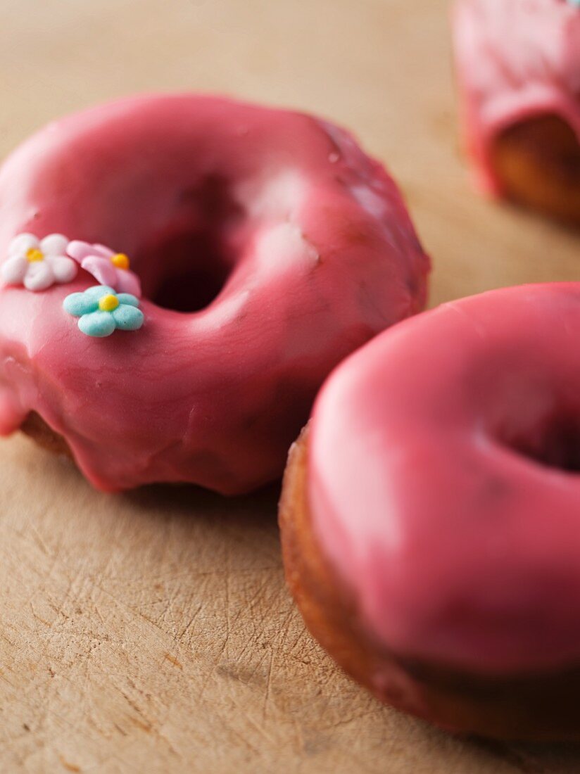 Pink Frosted Donuts with Flower Shaped Confection