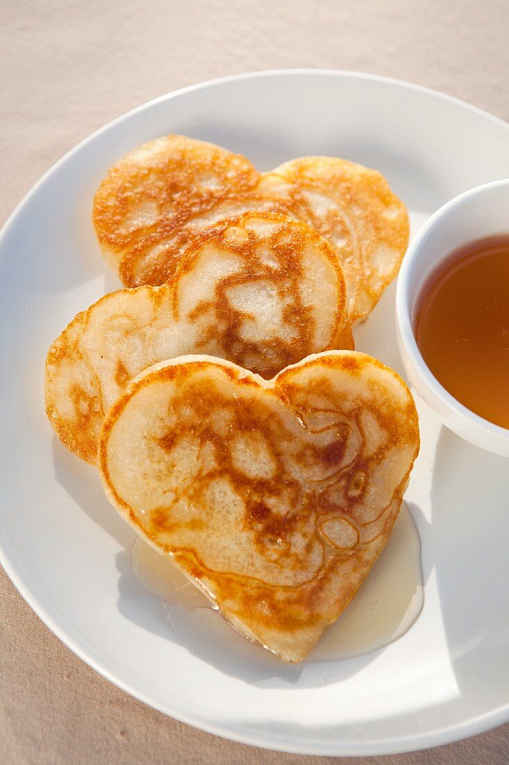 Heart-shaped flapjacks with syrup