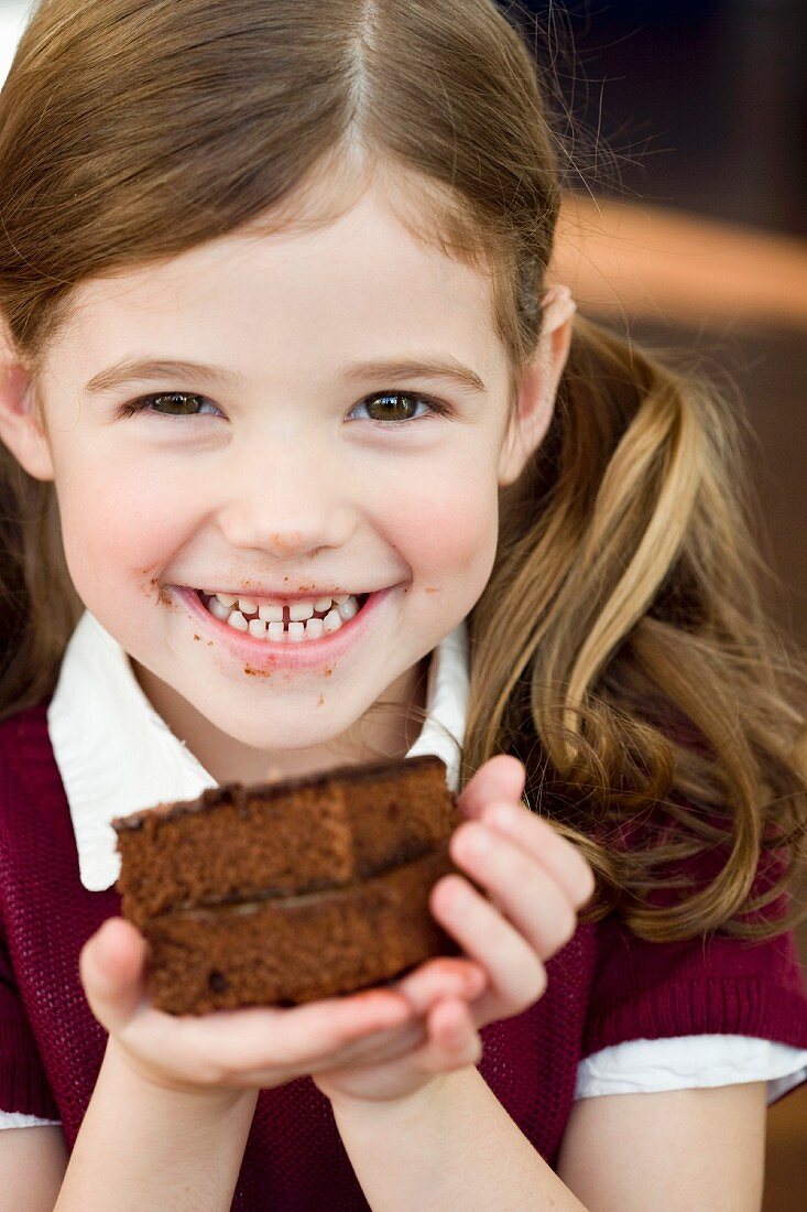 Girl holding an chocolate cake