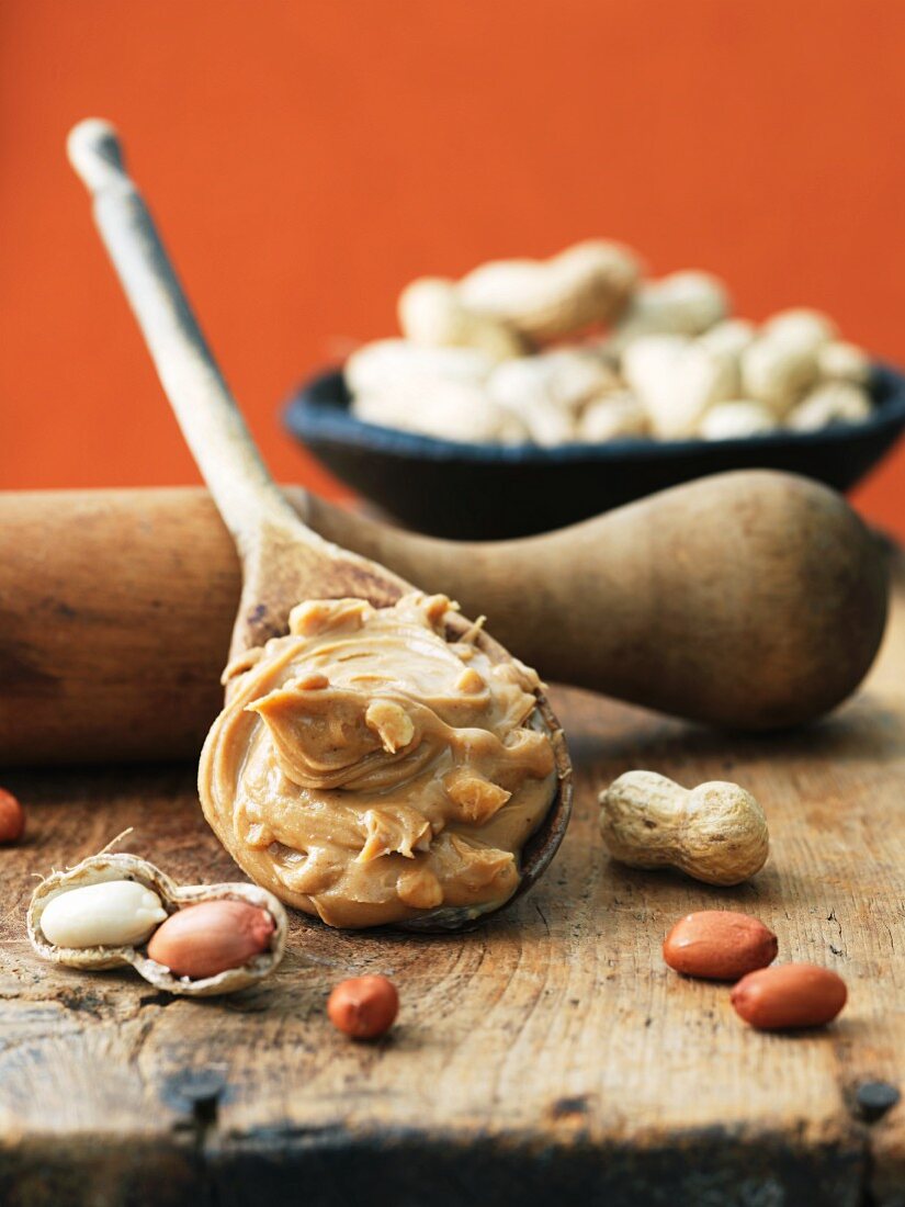 Wooden Spoon of Crunchy Peanut Butter; Peanuts