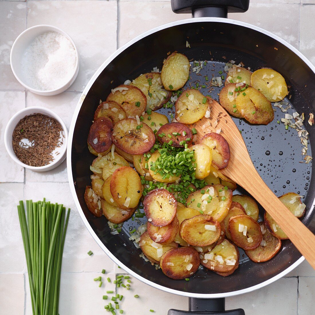 Fried potatoes with caraway and chives