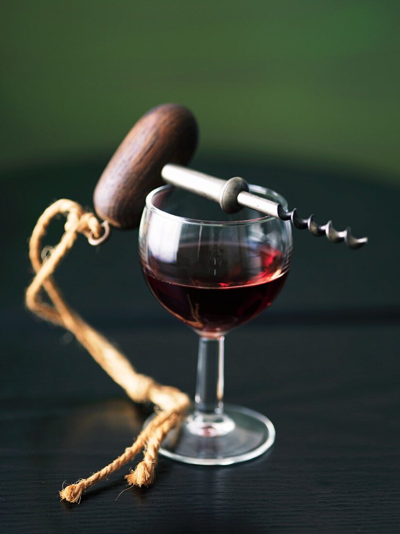Glass of Pinot Noir with a Corkscrew