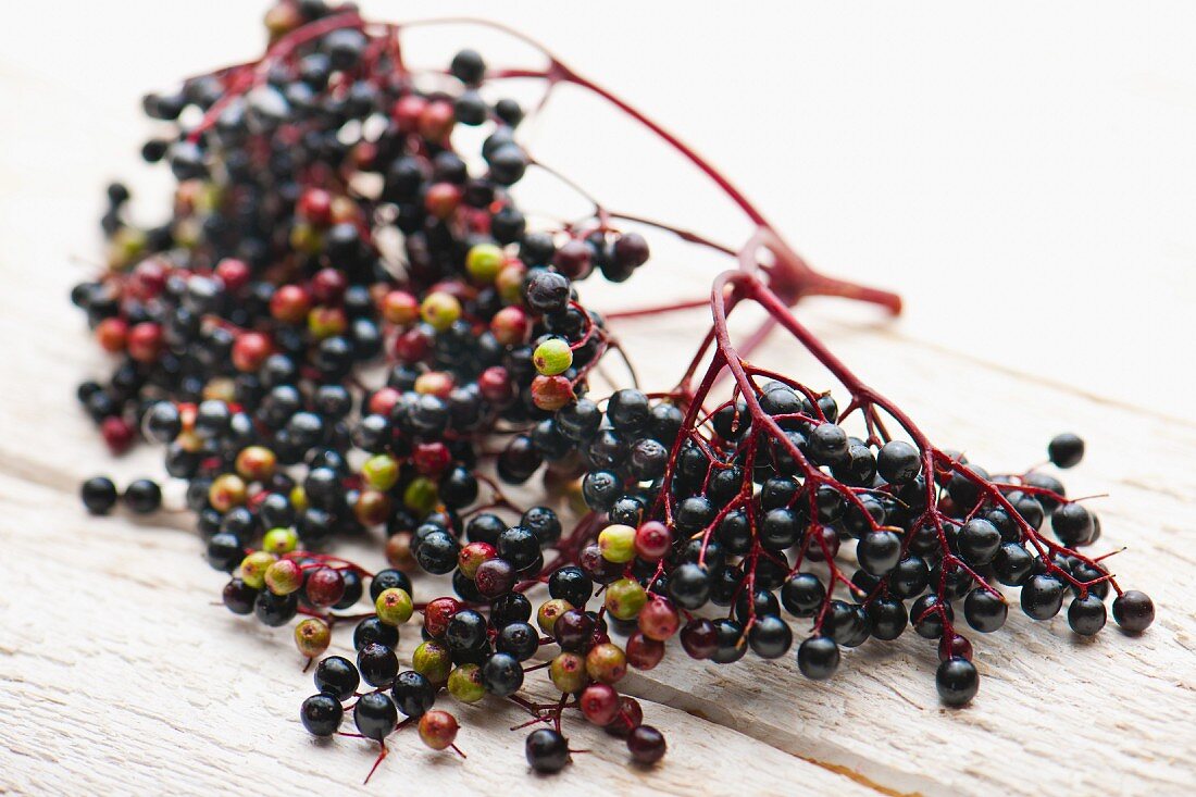 Elderberries on a white surface