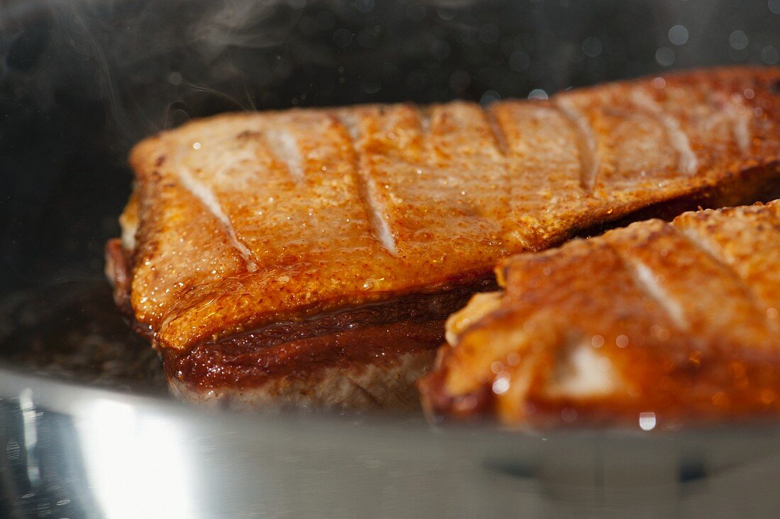 Duck breast in a pan (close-up)