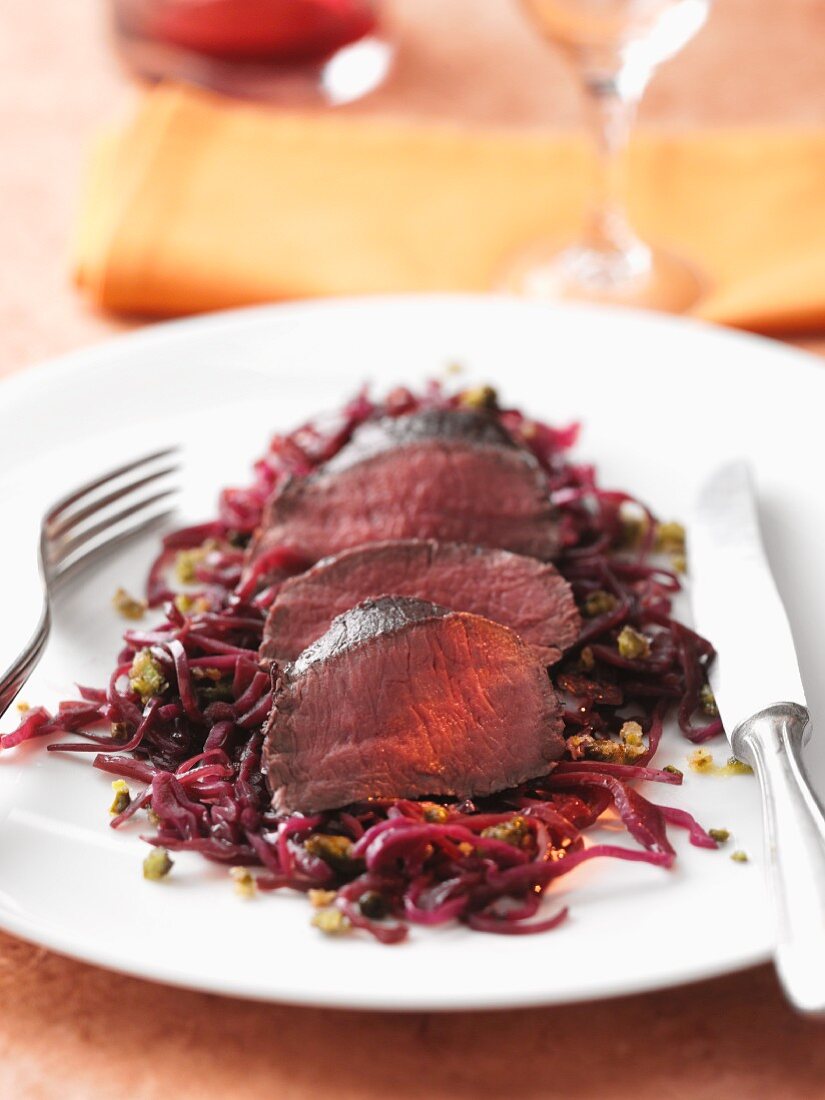 Venison fillet on a red cabbage medley with pistachios