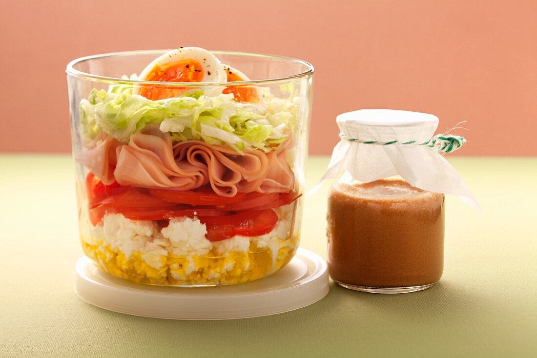 Layered salad with sheep's cheese and turkey slices