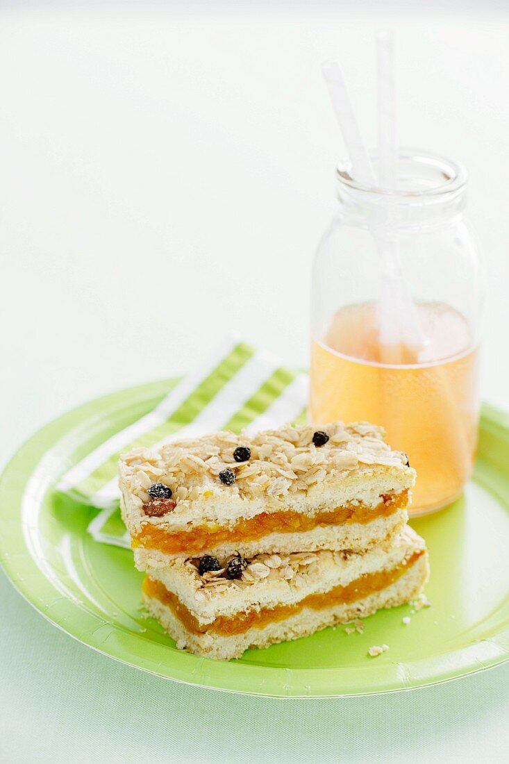 Muesli slices with apricots and a glass of juice