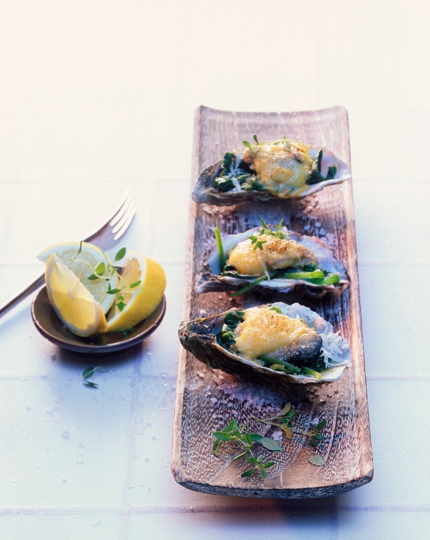 Oysters on spinach, topped with a cheese sauce and baked