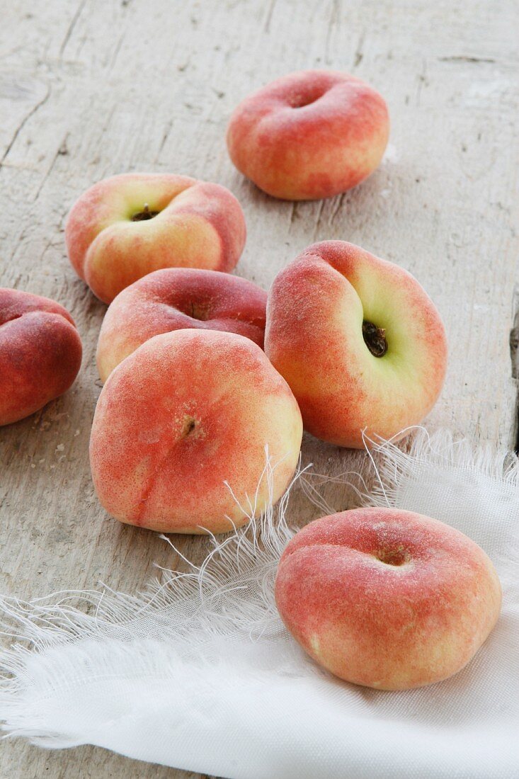 Peaches on a rustic wooden surface