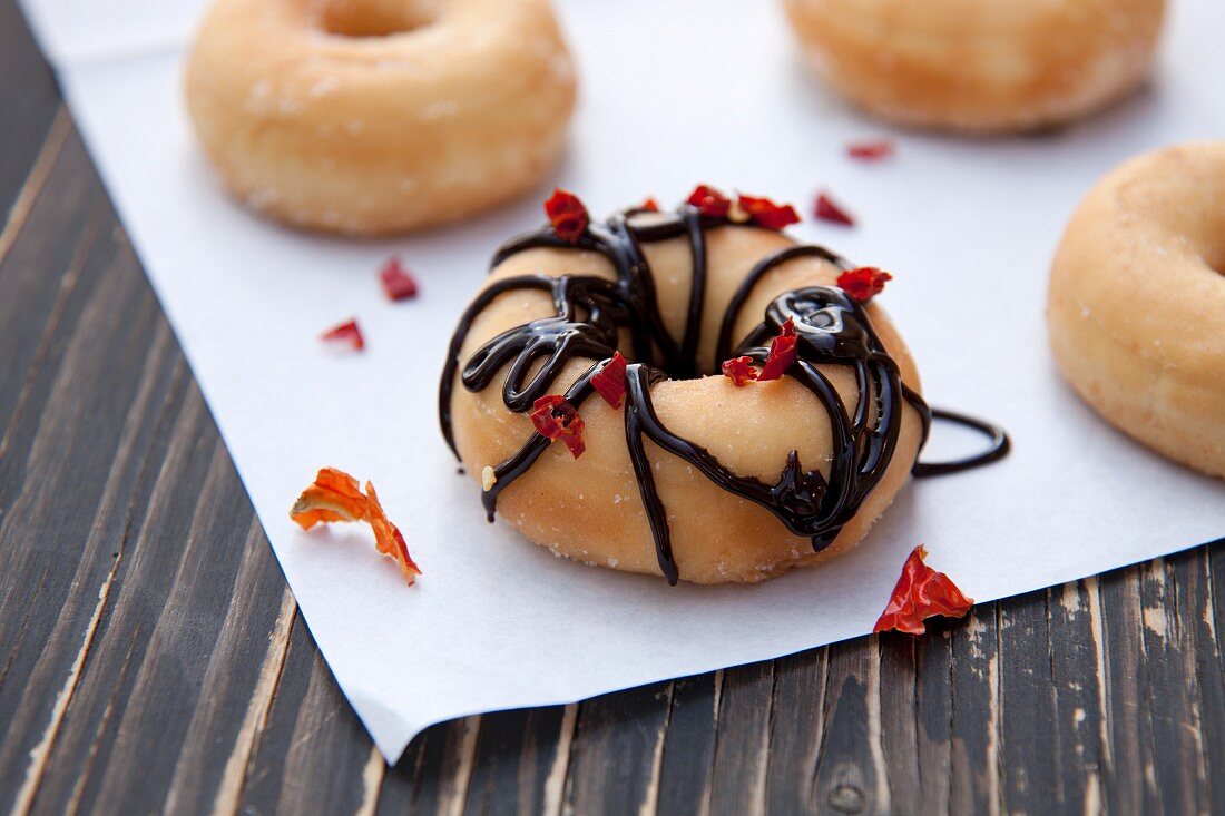 A doughnut with chocolate glaze and chilli