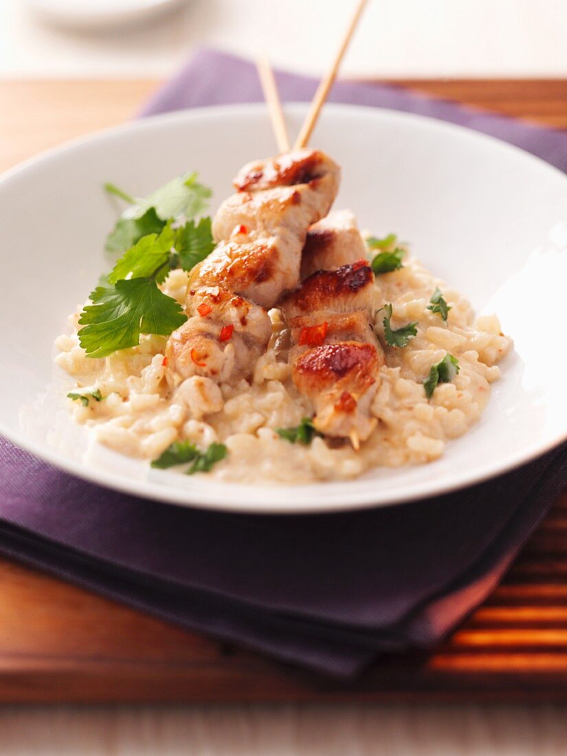 Sate kebabs on risotto