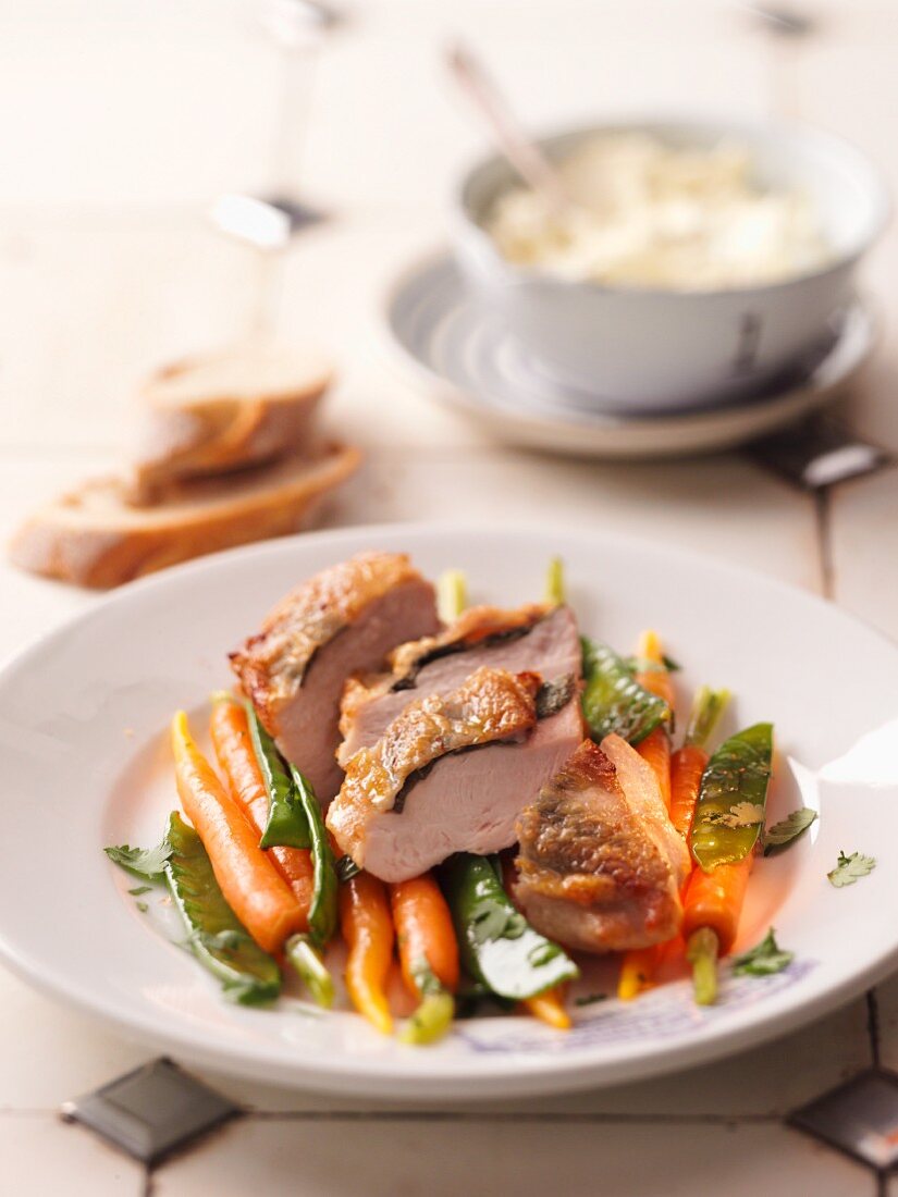 Sage chicken with carrots and mange tout