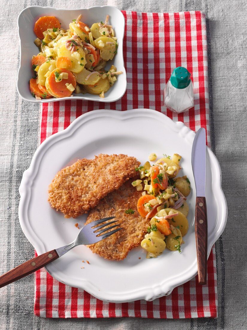 Veal escalope with a coconut coating and potato and carrot salad